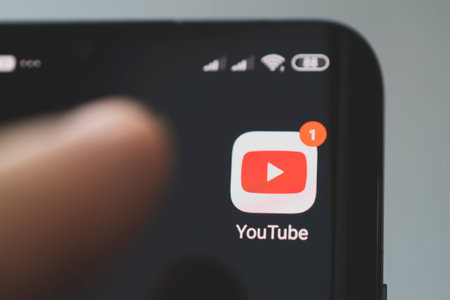 Icon of the YouTube, app on the screen of a black smartphone. Barnaul, Russia, February 10, 2021のeditorial素材