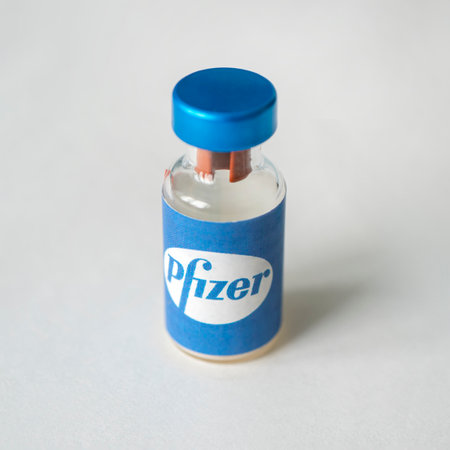Glass bottle with logo Pfizer, American multinational pharmaceutical company. January 18, 2021, Barnaul, Russia.のeditorial素材