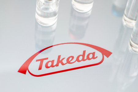 Vials of liquid on a white table and the  of a large pharmaceutical company. March 15, Barnaul, Russia.のeditorial素材