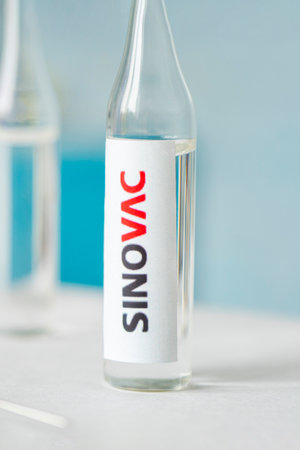 Glass bottle with Sinovac, Chinese pharmaceutical company. January 18, 2021, Barnaul, Russia.のeditorial素材