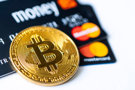 Gold bitcoin symbol and credit card master cards on the table. February 20, 2021, Barnaul, Russiaのeditorial素材