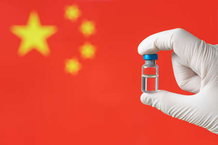 virus  Vaccine injection hand hold Doctor or nurse on flag China background. Protect immunization and treatment from  virus infection. medicine concept.の写真素材
