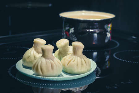 Homemade, Traditional Asian dumplings and pot on black background