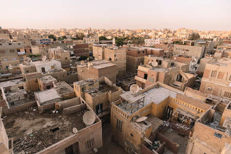 A unfavorable neighborhood for the poor population of the old town. Sheds on the roofs of houses.の写真素材