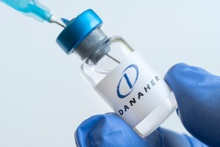 Vials of liquid on a white table and the logo Danaher Corporation, large pharmaceutical company....