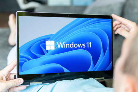 June 23, 2021. Barnaul, Russia. Windows 11 logo on the screens of a transformer laptop and a modern...