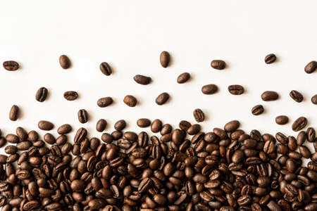 Coffee background or texture concept. Coffee beans isolated on white background with copyspace for...
