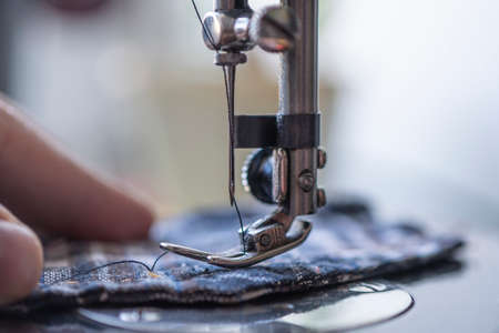 Close up image of a sew machine in use. factory production of clothing.の写真素材
