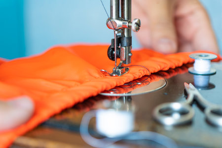 sewing machine and item of clothing. Sewing fabric on a sewing machine close-up