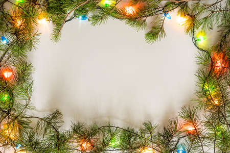 Bright Christmas frame of spruce, christmas decorations on white background. Copy space. Winter holidays, New Year.の写真素材