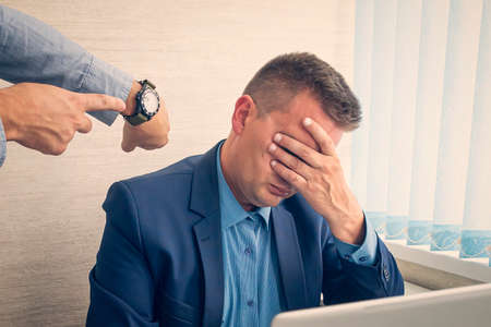 Keep track of time. man point at clock. Work time or working hours. Time management. Office life....