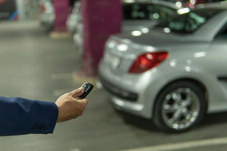 Close up hand a man Press the button of car keys remote for lock and unlock the car doorの写真素材