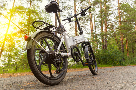 electric bike on an asphalt track in the forest without people. The concept of healthy walking and...
