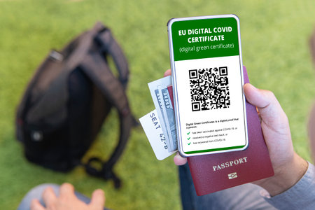 vaccinated person using digital health passport app in mobile phone for travel during covid-19 pandemic. green certificate. Certificate for confirming vaccination and the presence of antibodiesのeditorial素材