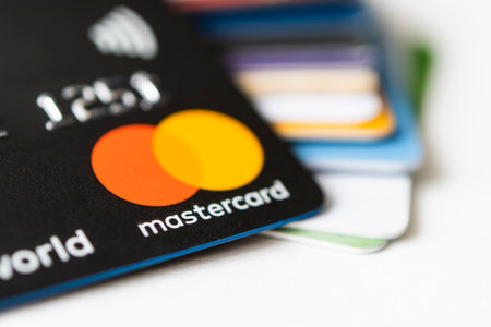 Lots of credit and debit cards on the table. The Mastercard logo on the cards. 20 February 2021,...
