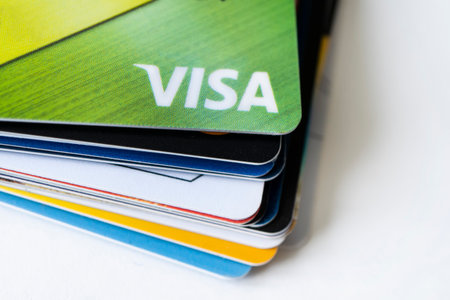 20 February 2021, Barnaul, Russia: Pile of VISA card, credit cards on the white table. shallow focus in soft tone. business concept.のeditorial素材