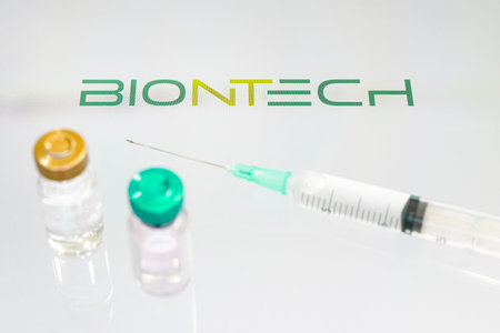 Glass bottle with logo biontech, german pharmaceutical company. January 18, 2021, Barnaul, Russia.のeditorial素材