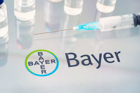 Vials of liquid on a white table and the logo Bayer, large pharmaceutical company. March 15, 2021. Barnaul, Russia.のeditorial素材