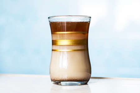 Glass Cup of coffee on the blue background of kitchen