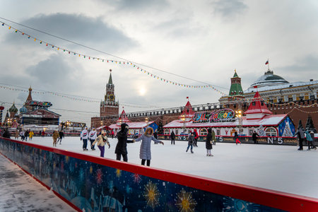 Winter skating rink on Christmas Fair at the Red Square and people are skating. December 21, 2021. Moscow, Russia.のeditorial素材