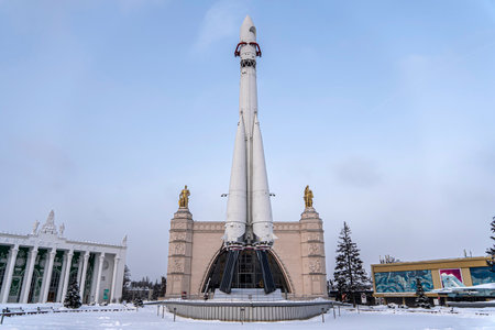 The world's first manned Vostok three-stage space rocket at an exhibition in Moscow. Against a background of blue sky and flakes of snow. Translation: USSR, Vostok. December 18, 2021. Moscow. Russiaのeditorial素材