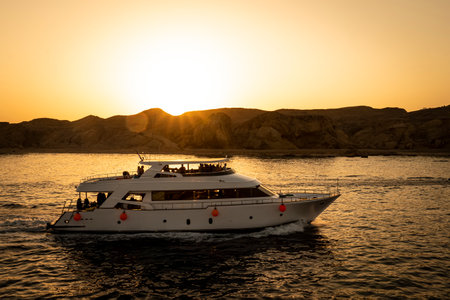 Tourists ride on a two-story yacht on the red sea against the backdrop of a bright sunset. Sharm el Sheikh Egypt. October 15, 2021のeditorial素材