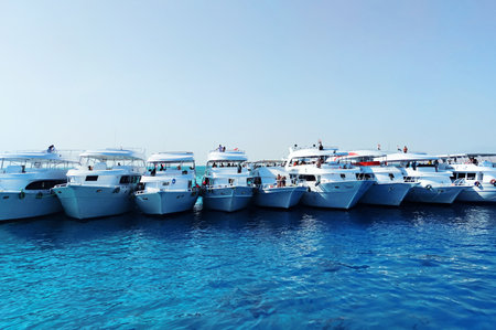 October 19, 2021. Egypt. Sharm El Sheikh: Lot off yachts against the backdrop of blue sky are anchored in the sea. Marine parking of boats and yachts in Egyptのeditorial素材