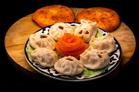 Manta rays with juicy meat on a plate on a wooden tray with baked piesの写真素材