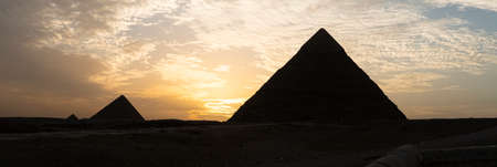 Archaeological complex of the Great Egyptian Pyramids is located on the Giza plateau. second pyramid of Chephren khefren in the night light at sunset. sun sets behind the pyramid.の写真素材