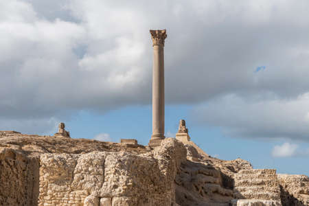 Ancient Roman artifacts at the excavations against the blue cloudy sky in the city of Alexandria. Egypt. Attractions.の写真素材