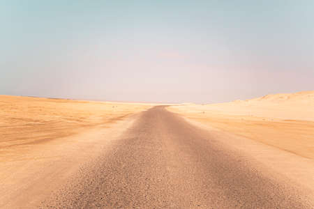 Landscape view of dusty road going far away nowhere in Wadi Rum desert,の写真素材