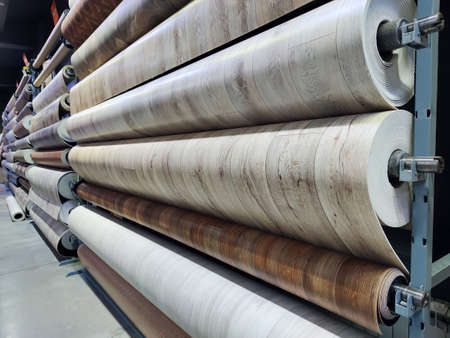 Rolls with linoleum in a shop window. Various types of flooring on sale at the bazaar. The rise in price of building materials concept.の写真素材