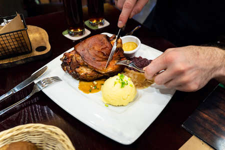 Czech dish - Veprevo knee in a dish with gravy pork knee with potatoes and honey mustardの写真素材