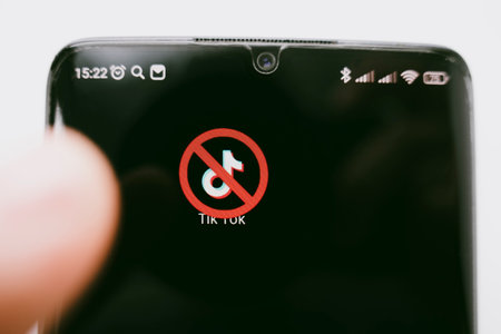 A crossed-out icon on a black smartphone screen. the concept of banning the application tick tok. April 1, 2022 Russiaのeditorial素材