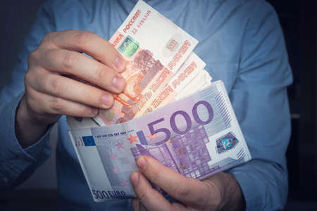 Hands take out russian rubles from wallet. Closeup on a man's hands as he is getting a banknote out...