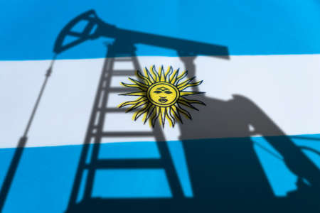 The oil industry of argentina. Oil rigs on the background of the argentine flag. Mining and oil export. trading on the global fuel market. fuel industry concept.の写真素材