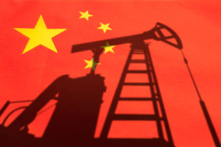 The oil industry of china. Oil rigs on the background of the chinese flag. Mining and oil import. trading on the global fuel market. fuel industry concept.の写真素材