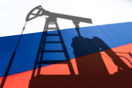 The oil industry of Russia. Oil rigs on the background of the Russian flag. Mining and oil export. trading on the global fuel market. fuel industry concept.の写真素材