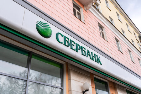 Facade of the Sberbank branch - Sberbank with an sign. Russian financial conglomerate, the largest universal bank in Russia and Eastern Europe. April 9, 2022. Russia Barnaul.のeditorial素材