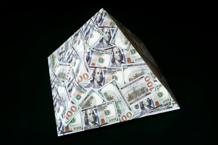 a pyramid scheme on a black background. The concept of financial fraud. The dollar as a global financial pyramid.の写真素材