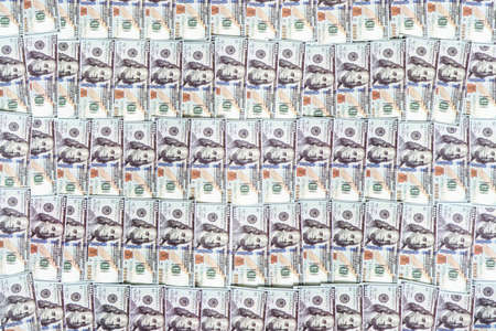 Background with money american hundred dollar bills. lot of paper bills of American dollars on the background.の写真素材