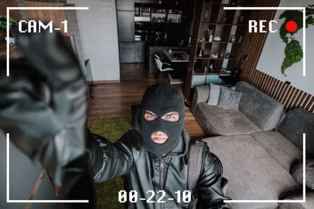 Being Caught. Robber entering house, holding crowbar and looking at CCTV camera, high angle view...