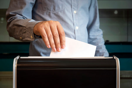 Voting box and election image. a man votes at a polling station