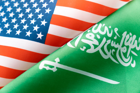 Background of the flags of the USA and saudi arabia. The concept of interaction or counteraction between the two countries. international relations. political negotiations. sports competition.の写真素材