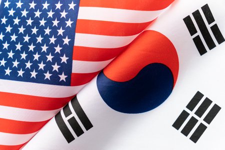 Background of the flags of the USA and Korea. The concept of interaction or counteraction between...