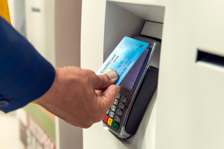 Unrecognizable businessman in suit pays for purchases in the store with a contactless credit card....