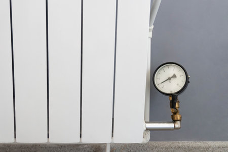 barely warm battery during heating season. Heating devices in the house. pressure measuring device or thermometer in the heating pipe.の写真素材