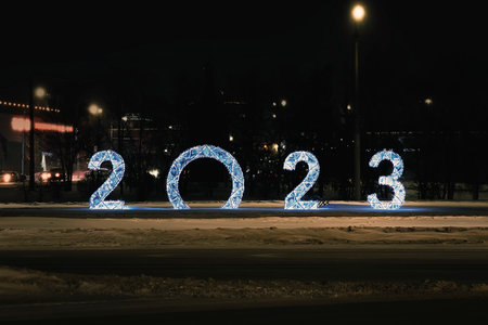 2023 figures on snow on a dark night background. Decorative figures decorate the city square for the...
