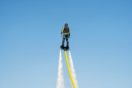 flyboard. Air Farthest flight by hoverboard. Man flying on Board. Flyboard is aerial machine for personal watercraft, allows propulsion underwaterの写真素材
