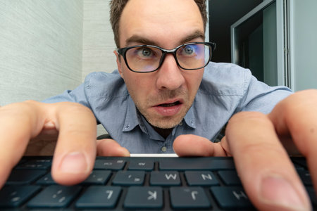 Funny and crazy man using a computer on white background. man's hands on keyboard